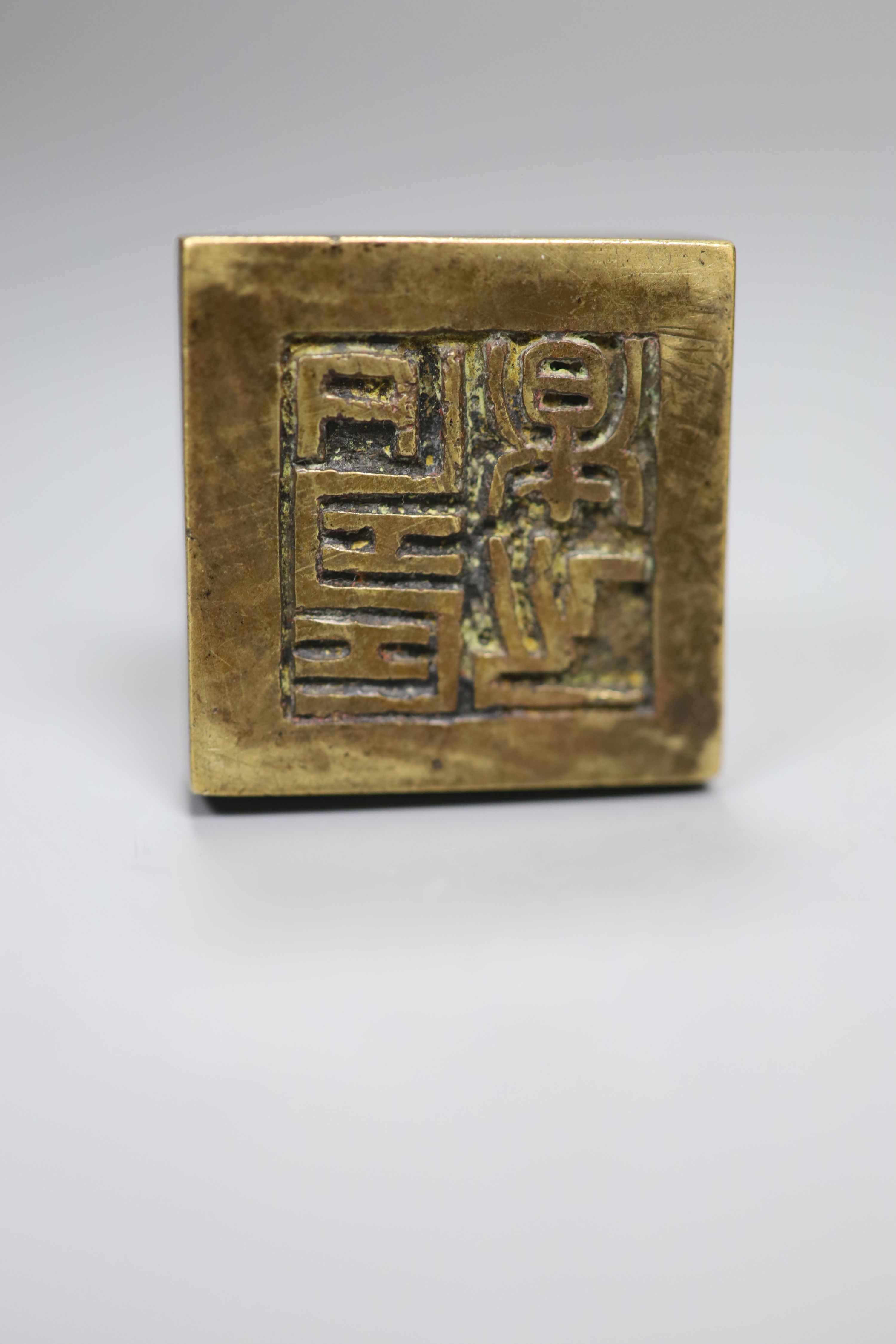 A group of Chinese bronze seals and a white metal elephant